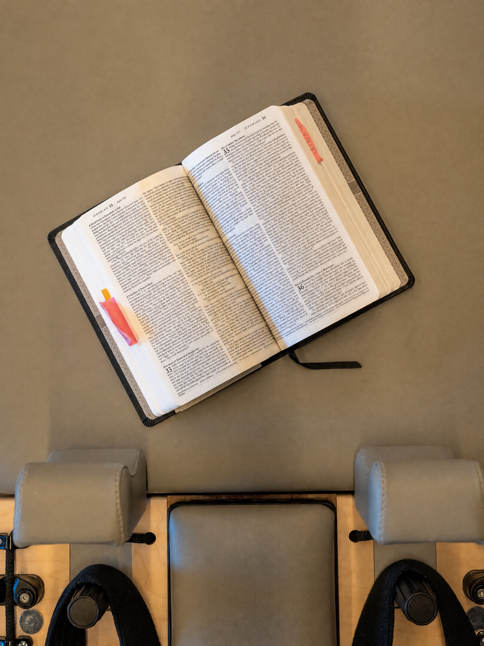 Open Bible resting on a Renewed Pilates reformer